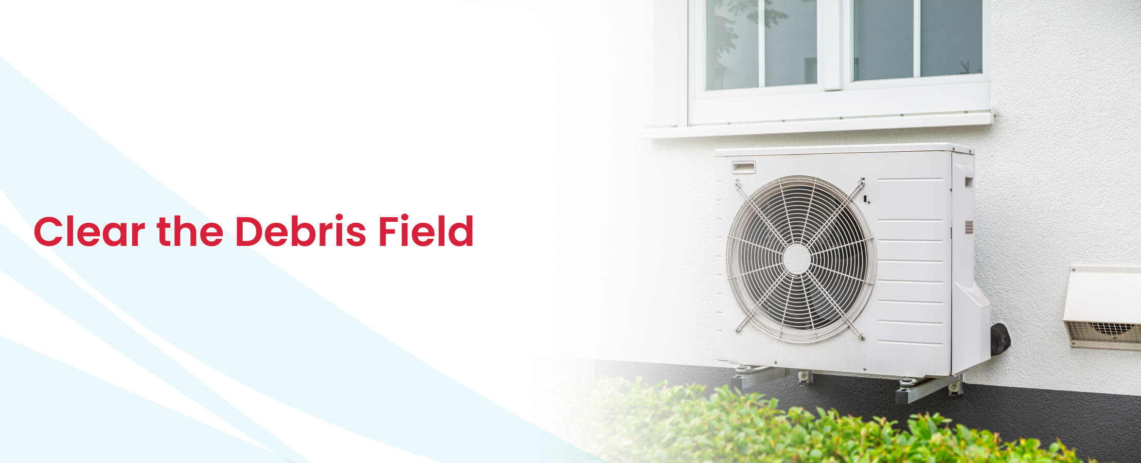 Reverse cycle outdoor unit mounted on exterior wall, clear debris field for airflow.